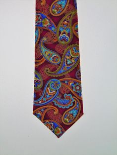 "This cotton print Necktie features a beautiful paisley design with a hint of metallic. Colors include metallic gold, cream, rust, dark rust, gold, beige, shades of blue and purple, green and dark magenta Expertly hand-made from 100% cotton you can select your length from 57\" to 71\" (Great for taller Men). Width is standard 3.5\" as shown here or skinny 2.5\". If you require a custom length or width, please contact us. 2.5\" x 48\" Child size available upon request. Ships within 2 business day Elegant Multicolor Paisley Print Suit And Tie Accessories, Multicolor Paisley Print Suit And Tie Accessories For Business, Elegant Multicolor Paisley Print Ties, Formal Multicolor Paisley Suit And Tie Accessories, Formal Patterned Paisley Suit And Tie Accessories, Formal Patterned Ties With Paisley Print, Classic Paisley Print Patterned Ties, Beige Shades, Purple Gothic