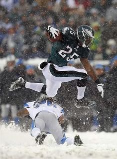 a football player jumping up into the air