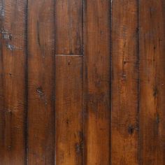 an orange cat laying on top of a wooden floor