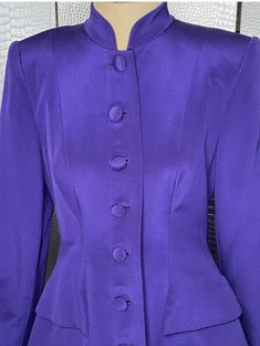 John Anthony Couture Purple Jacket And Pants Suit. This is an amazing deal for a couture suit. Great for formal events like weddings. Jacket has an extended hem and Mandarin collar, and could be worn as a minidress. Pants have a zipper closure and are wide-legged. In a beautiful deep purple, straight from the 1980s. Approximate Measurements: Jacket 17" across chest 32" long, 15.5" across shoulders 5.5" across waist Pants 13" across waist 11.5" wide hem As this suit is vintage, normal signs of wear and age are to be expected. Suit is in good condition, few small pulls on shoulder and small stain on sleeve as shown. Please examine photos carefully, and message with questions, as this is sold as-is. Fitted Party Suit With Button Closure, Party Fitted Suits With Button Closure, Fitted Party Suit With Buttons, Elegant Formal Pantsuit With Buttons, Elegant Fitted Pantsuit With Button Closure, Fitted Long Sleeve Pantsuit With Button Closure, Party Fitted Blazer With Covered Buttons, Elegant Spring Suits With Button Closure, Fitted Long Sleeve Suit For Evening