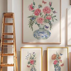 there are paintings on the wall with flowers in them and a ladder next to it