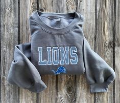 Detroit Lions varsity design. I can do any player name and number on the back. Leave it in a note for specific players! This is the hoodie version. Lions Spirit Wear, Detroit Lions One Pride, Detroit Lions Shirt, Detroit Lions Hoodie, Dan Campbell Detroit Lions, Detroit Lions, Lion, Art Collection, Sweatshirts Hoodie