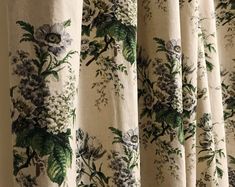 the curtains are covered with flowers and leaves