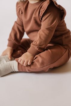 Rediscover our classic French Terry Sweatshirt for baby, with a signature ruffle sleeve. Available in three soft hues with ribbed trim and back snaps for easy on-and-offs, we love it pehr-ed with our French Terry Harem Pants or Essential Legging for a complete set! Made in 100% organic French Terry cotton, each piece of this collection is garment dyed for a vintage washed look and has the softest hand-feel. Organic Cotton & Dyes Soft Hands, Bottom Clothes, French Terry, Harem Pants, Dress Shop, Overalls, Organic Cotton, Kids Outfits, Rompers