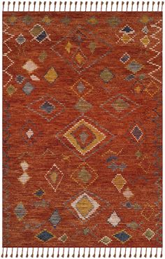 an orange rug with many different colored squares and diamonds on the bottom, along with fringes