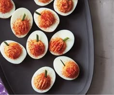 deviled eggs with tomato sauce on a tray