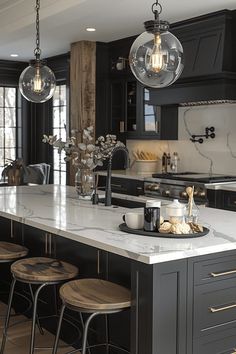 a large kitchen with marble counter tops and black cabinets