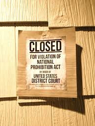 a close up of a sign on a wooden wall