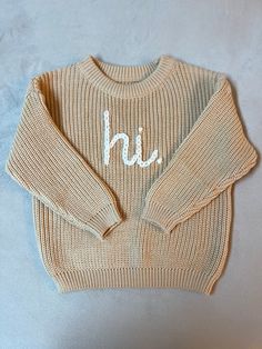 Customize this hand embroidered crewneck sweater in the colors of your choice and your favorite greeting (Hi, Hello, Ciao, Bonjour, Hola, etc.). Please list the sweater color, yarn color and greeting in the personalization box. If you have a specific request or do not see a color that you want, please message me. I'm happy to work with you to bring your vision to life!  This sweater makes a great birthday gift, baby shower gift, pregnancy announcement, birth announcement or just because!  Recomm Unique Baby Gift, Toddler Sweater, Unique Baby Gifts, Embroidered Crewneck, Sweatshirt Cute, Gender Neutral Baby Clothes, Great Birthday Gifts, Unique Baby, Sweater Making