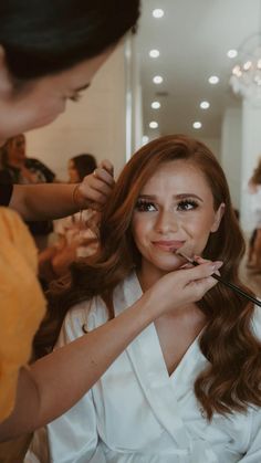 a woman is getting her hair done at the salon