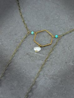 Capture the impactful symbology of natural gemstones with this artisan paperclip chain bolo necklace. Adorned with a single natural keshi pearl, genuine Arizona Sleeping Beauty turquoise, micro faceted amazonite rounds & a hammered hexagon, this intentional necklace reflects the symbolism found throughout life's journey. Embrace the essence of the Desert & the Sea with peace of mind knowing this necklace was handcrafted in the USA with ethically sourced gemstones that tell a unique story. Baroque Keshi Pearl Paperclip Chain Bolo Necklace Ft. Genuine Arizona Sleeping Beauty Turquoise (Necklace Only): ✿ Antiqued brass, raw USA brass, natural baroque freshwater keshi pearl, genuine Arizona Sleeping Beauty turquoise, micro faceted Peruvian amazonite Please note - Items are made with raw bronze Turquoise Aquamarine Gemstone Beads Necklace, Turquoise Rectangular Pendant Necklace With Gemstone, Ocean-inspired Turquoise Necklace With Natural Stones, Ocean-inspired Turquoise Pendant Necklace, Turquoise Gemstone Square Pendant Necklace, Bolo Necklace, Sacred Stones, Arizona Turquoise, Sleeping Beauty Turquoise