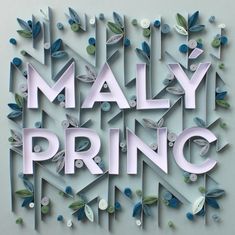 the word maly princ surrounded by paper flowers and leaves