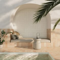 a white couch sitting next to a swimming pool under a palm leafy tree on top of a tiled floor