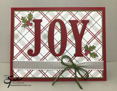 a christmas card with the word joy in red and white, on top of a plaid background