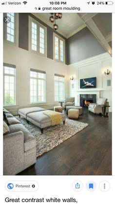 a living room filled with lots of furniture next to a fire place in a building