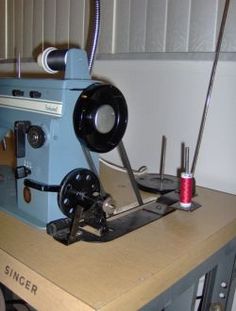 an old sewing machine sitting on top of a wooden table