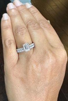 a woman's hand with a diamond ring on it