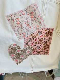 several pieces of fabric with different patterns on them, including one heart and the other patchwork