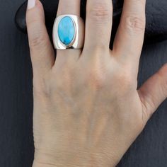 Infuse stunning color into your look with this extra wide silver ring. Oval turquoise stone radiates luscious blue hues at the center of a modern thick silver band. Gemstone - Genuine Turquoise 925 Sterling silver High polish finish Approx. 1" L x 0.9" W Handmade in Taxco, Mexico Due to the uniqueness of gemstones, there may be slight variations in color or pattern. Wide Silver Ring, Wide Band Ring, Wide Band Rings, Ring Oval, Jewel Box, Genuine Turquoise, Wide Bands, Blue Hues, Turquoise Sterling Silver