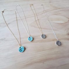 "These adjustable 16\"-18\" necklaces have 1/2\"x 1/4\" charms, which are a dainty-yet-noticeable addition to any outfit. Each charm is handmade and stamped with an upward print,  fired, then coated with glaze on one side and refired. The backside of the charm is left unglazed, open-surface for diffusing essential oils (or perfumes). The ceramic bead becomes warm as you wear it, and in turn, the aroma of the oil will be released. One drop of my favorite essential oil (Stress Away) on the back an Nickel-free Round Pendant Necklaces For Friendship, Nickel Free Round Pendant Necklaces For Friendship, Nickel-free Round Pendant Necklace For Friendship, Adjustable Friendship Pendant Necklace, Blue Adjustable Necklace For Friendship, Adjustable Pendant Charm Necklace For Everyday, Adjustable Blue Necklace For Friendship, Adjustable Pendant Necklace For Friendship, Nickel-free Minimalist Friendship Necklaces