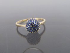 Vintage 18K Solid Yellow Gold Blue Sapphire Ball Pave Ring...Marked 18K...Total of weights 1.8grams... Size 6....With 48 Blue Sapphires 1MM ( .005ct x 48 = .28ct ) Measure of Face 8MM...It's in very good condition. 14k Gold Blue Sapphire Ring With 17 Jewels, Blue Diamond Promise Ring With 17 Jewels, Blue Cluster Ring In 14k Gold, Blue Cluster Rings In 14k Gold, 14k Gold Cluster Ring With Blue Color, Blue Cluster Rings As Gifts, Blue Cluster Rings For Gifts, Blue Hallmarked Cluster Ring, Blue 14k Gold Cluster Ring