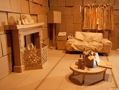 a living room filled with furniture next to a fire place in the middle of a room