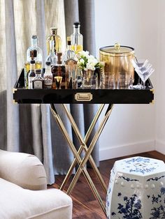 a bar cart filled with liquor bottles and glasses