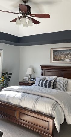 a bedroom with a large bed and ceiling fan