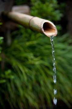 a wooden pipe with water coming out of it