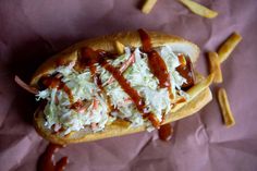 a hot dog covered in coleslaw and ketchup