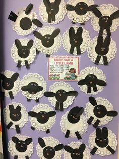 a bulletin board with black and white paper cut out of sheep