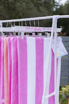 pink and white towels are hanging on a rack