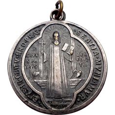 an antique medal with the image of mary and jesus on it's back side