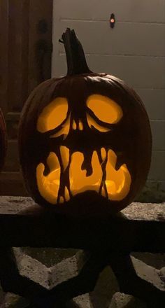 two pumpkins with faces carved into them