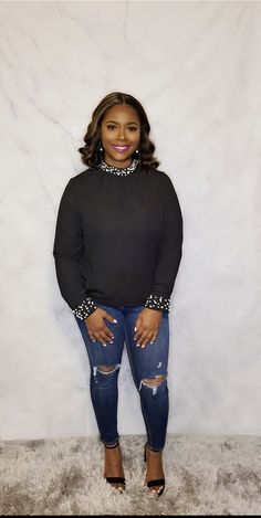 Long sleeve top with pearl embellishments on neck and cuffs. Button closure back and cuffed sleeves with buttons. Lightweight, non sheer. 100% Polyester Black Button Down Shirt, Pearl Strand, Embellished Top, Pearl Strands, Dress Ideas, Black Button, Cuff Sleeves, Long Sleeve Top, Embellishments