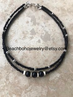 This beautiful double strand beaded Anklet for women is made with black glass beads, silver metal beads, black network stones, and white howlite beads. Ankle bracelet comes in several sizes, just choose your size from the drop down menu at checkout. Black Beaded Anklets For Festival, Black Beaded Festival Anklets, Handmade Adjustable Black Anklet, Black Anklets With Round Beads For Gift, Black Bohemian Anklets With Black Beads, Black Beaded Choker For Beach, Black Beaded Beach Choker, Black Bohemian Beaded Anklets, Adjustable Black Anklet With Tiny Beads