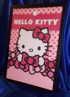 a hello kitty cross stitch pattern on a blue velvet background with the words hello kitty