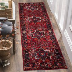 a red rug on the floor in a hallway