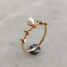 ITEM DESCRIPTION: >>The ring is made from Solid 14K Yellow Gold.  >>Gemstone used is absolutely natural and ethically sourced.  >>Natural Round shape Pearl and Ruby ring in bezel setting is studded on it with utmost precision.  Gem: Pearl  Gem size & shape: 4 mm and Round Gem weight: 0.39 carats Gem: Ruby Gem size & shape: 1.25 mm Round (5pcs) Gem weight: 0.041 carats Total Gems weight: 0.43 carats Gold purity: 14K (58.33% approx.) Gold weight: 1.11 grams Gross weight of ring: 1.20 grams The Gold purity is guaranteed and it comes with authentic 14K gold hallmark. Since these Rings are handmade, they are Nickel/Lead FREE.  CUSTOMIZATION: >>Size Customization is available for this ring and it is available in all ring sizes. >>Gemstone customization is also available and the main gemstone can 14k Gold Cluster Ring With Gemstone Accents As Gift, Fine Jewelry Pearl Ring With Birthstone For Gift, Multi-stone 14k Gold Ruby Ring For Gift, Fine Jewelry Pearl Ring As Gift, Exquisite 14k Gold Ruby Ring Gift, Unique 14k Gold Ruby Ring As Gift, Fine Jewelry 14k Gold Birthstone Pearl Ring, 14k Gold Pearl Birthstone Ring Fine Jewelry, 14k Gold Pearl Ring With Gemstone