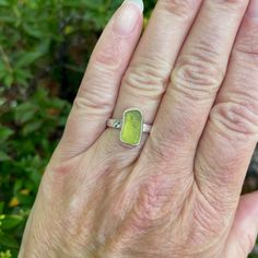 Do you need a gift for someone who is hard to buy for? Do you need jewelry for a tropical vacation or beach wedding? Sea glass jewelry is always a great gift to give! Here are the details about this ring:This is a small olive green piece of sea glass that is set in a fine & sterling silver fancy bezel and soldered to a sturdy band. All of our sea glass is found and never altered in any way. This piece was found in Europe somewhere! Handmade by Barb Macy in Corvallis, OR. Size 6 1/2 Adjustable Sea Glass Ring Jewelry, Handmade Sea Glass Ring Jewelry, Green Recycled Glass Jewelry For Healing, Healing Green Recycled Glass Jewelry, Healing Green Jewelry From Recycled Glass, Handmade Green Rings With Recycled Glass, Green Stackable Jewelry For The Beach, Beach-ready Green Stackable Jewelry, Green Recycled Glass Beach Jewelry