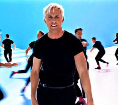 a man standing in front of a group of people with skateboards on their feet