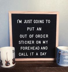 two coffee mugs sitting next to a sign that says i'm just going to put an out of order sticker on my forehead and call it a day