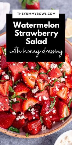 a bowl filled with strawberries and topped with feta cheese, on top of a table