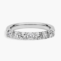 a white gold wedding ring with five stones on the side and four rows of diamonds