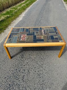 a coffee table made out of tiles on the side of a road