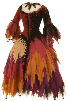 a dress made out of feathers on display in front of a white background with an orange, red and black color scheme