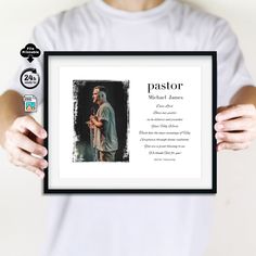 a man holding up a framed photo with the words pastor and an image of jesus