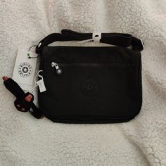 Kipling Callie Black Tonal Crossbody. Color: Black Tonal. Size: 10.5"L X 7.5"H X 4.5"D. Can Hold 5l Volume. Zip Closure With Front Zip Pocket. Interior Split With Nylon Divider For Organizing. Has Soft Monkey Keychain. Has Tags. Monkey Keychain, Kipling Handbags, Stylish School Bags, Kipling Bags, Green Purse, Popular Bags, Mini Crossbody Bag, Small Crossbody Bag, Cute Bags