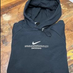 Black Women’s Nike Hoodie. Drawcord Hoodie With Two Front Pockets. Silver Swoosh With White Nike Lettering On The Front. Nike Hoodie With Letter Print, Nike Fleece Hoodie With Letter Print, Nike Hooded Sweatshirt For Streetwear, Nike Hooded Hoodie For Streetwear, Trendy Nike Winter Sweatshirt, Nike Black Hoodie For Fall, Nike Urban Black Hoodie, Trendy Black Sweatshirt With Branding, Nike Black Hoodie For Winter