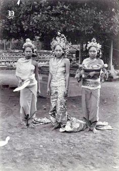 three women standing next to each other on a field